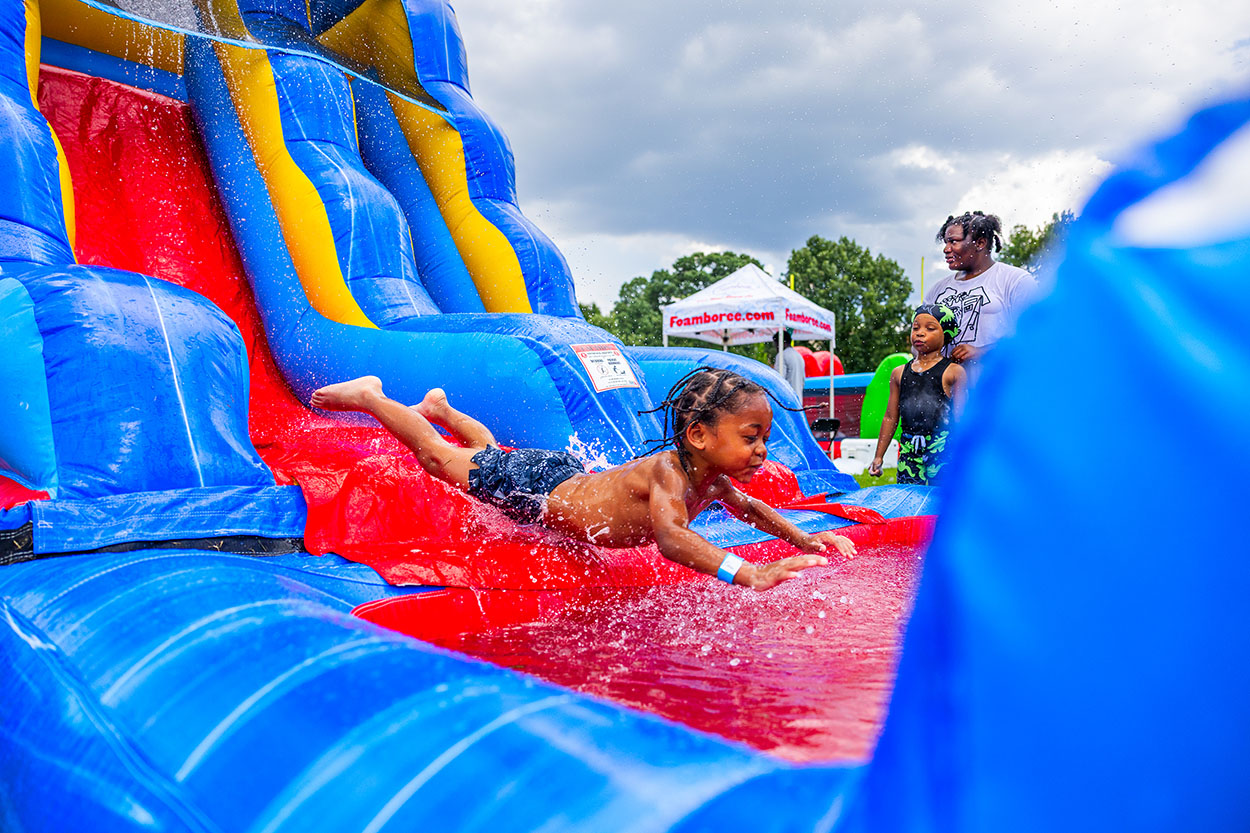 Approximately 250 residents, families and friends from the neighborhood enjoyed bounce houses, a water slide, foam bubbles, various games, face painting, food, live music and more. Children in attendance were thrilled to see Woody from the Toy Story movies at the party. Attendees were able to connect and enjoy the day together, further strengthening community bonds.