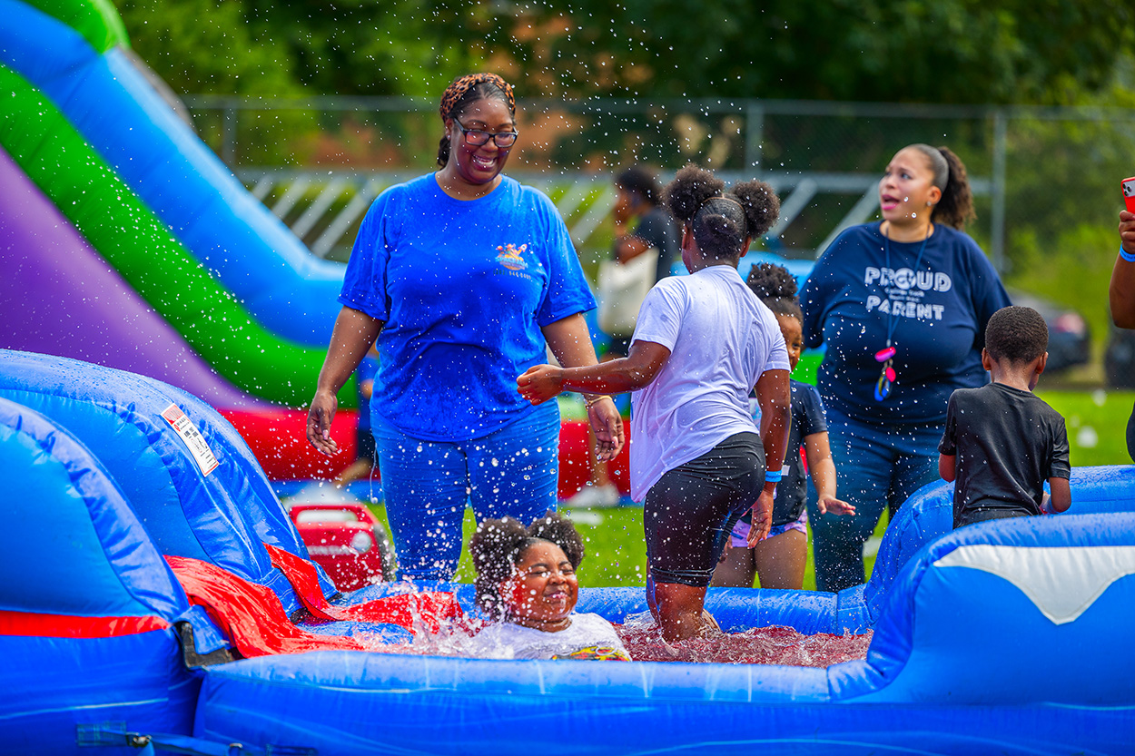 Approximately 250 residents, families and friends from the neighborhood enjoyed bounce houses, a water slide, foam bubbles, various games, face painting, food, live music and more. Children in attendance were thrilled to see Woody from the Toy Story movies at the party. Attendees were able to connect and enjoy the day together, further strengthening community bonds.