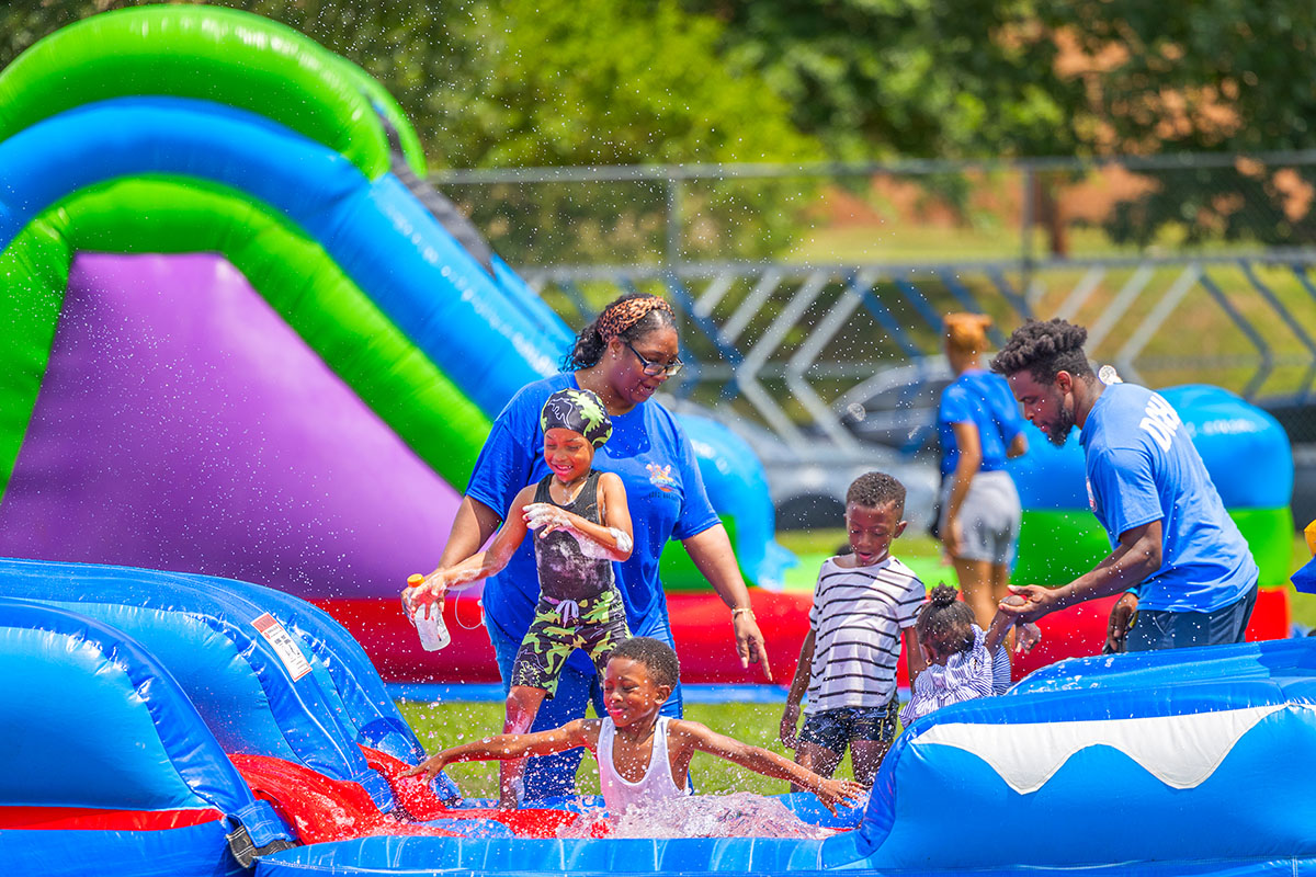Approximately 250 residents, families and friends from the neighborhood enjoyed bounce houses, a water slide, foam bubbles, various games, face painting, food, live music and more. Children in attendance were thrilled to see Woody from the Toy Story movies at the party. Attendees were able to connect and enjoy the day together, further strengthening community bonds.
