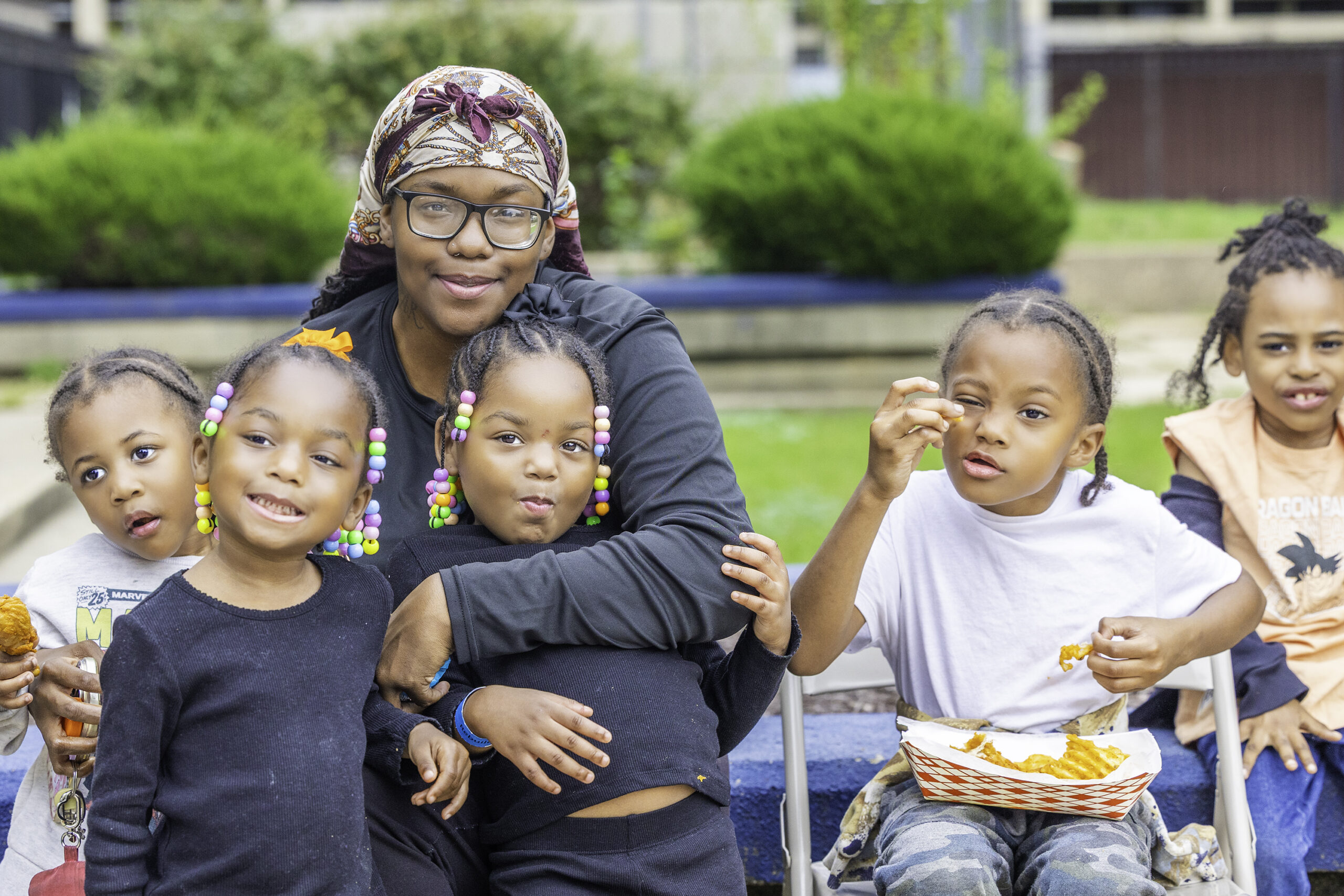 A DCHA family smile for a group photo while enjoying food during the community event.
